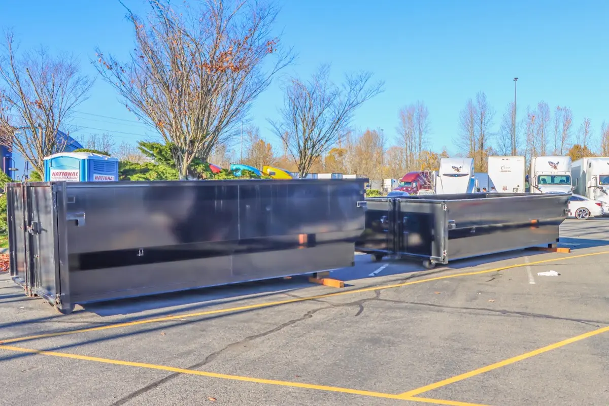 Professional dumpster rental service with roll-off container on residential driveway in Scottsburg